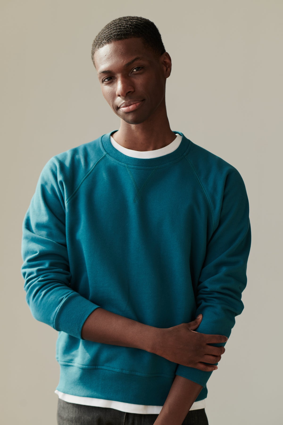Front of male in men's raglan sweatshirt in teal