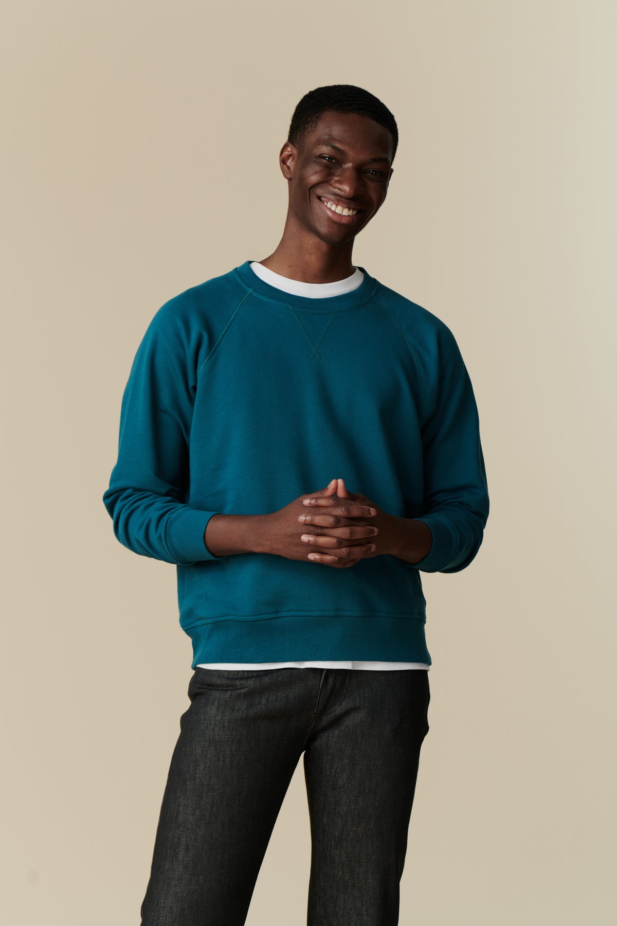 Front of male in men's raglan sweatshirt in teal