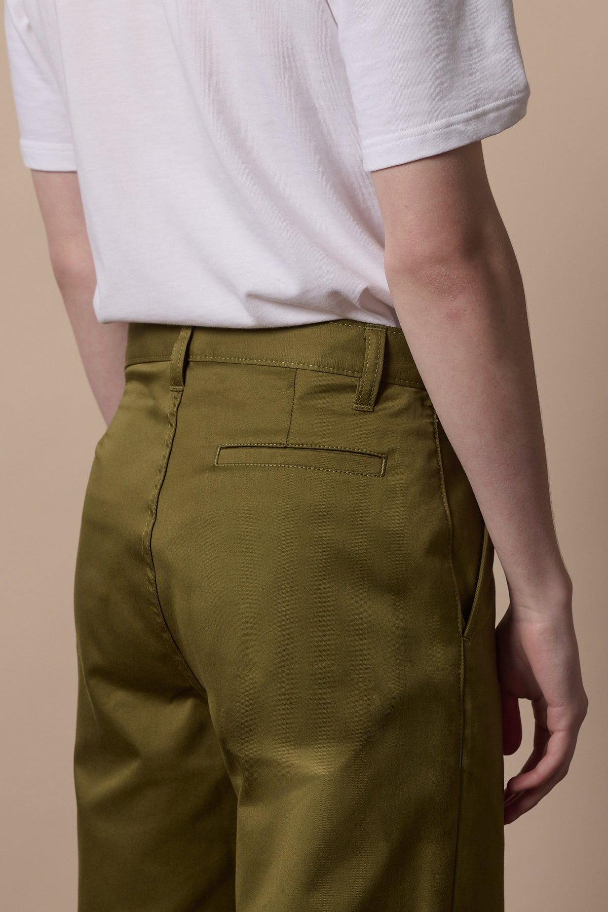 Back of male wearing relaxed chino in moss with white short sleeve t shirt tucked in