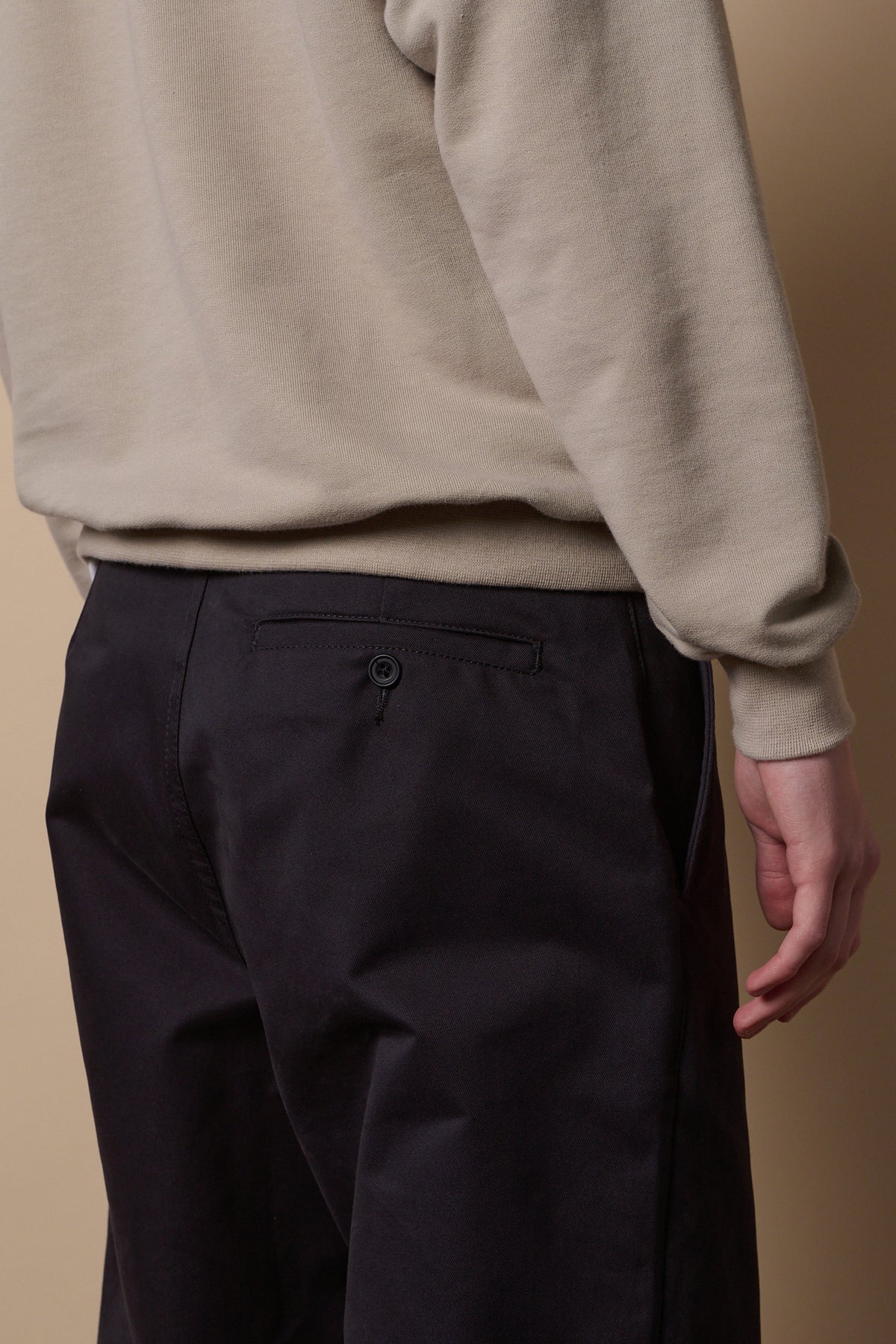 Back pocket with button detail of men's relaxed chino in navy