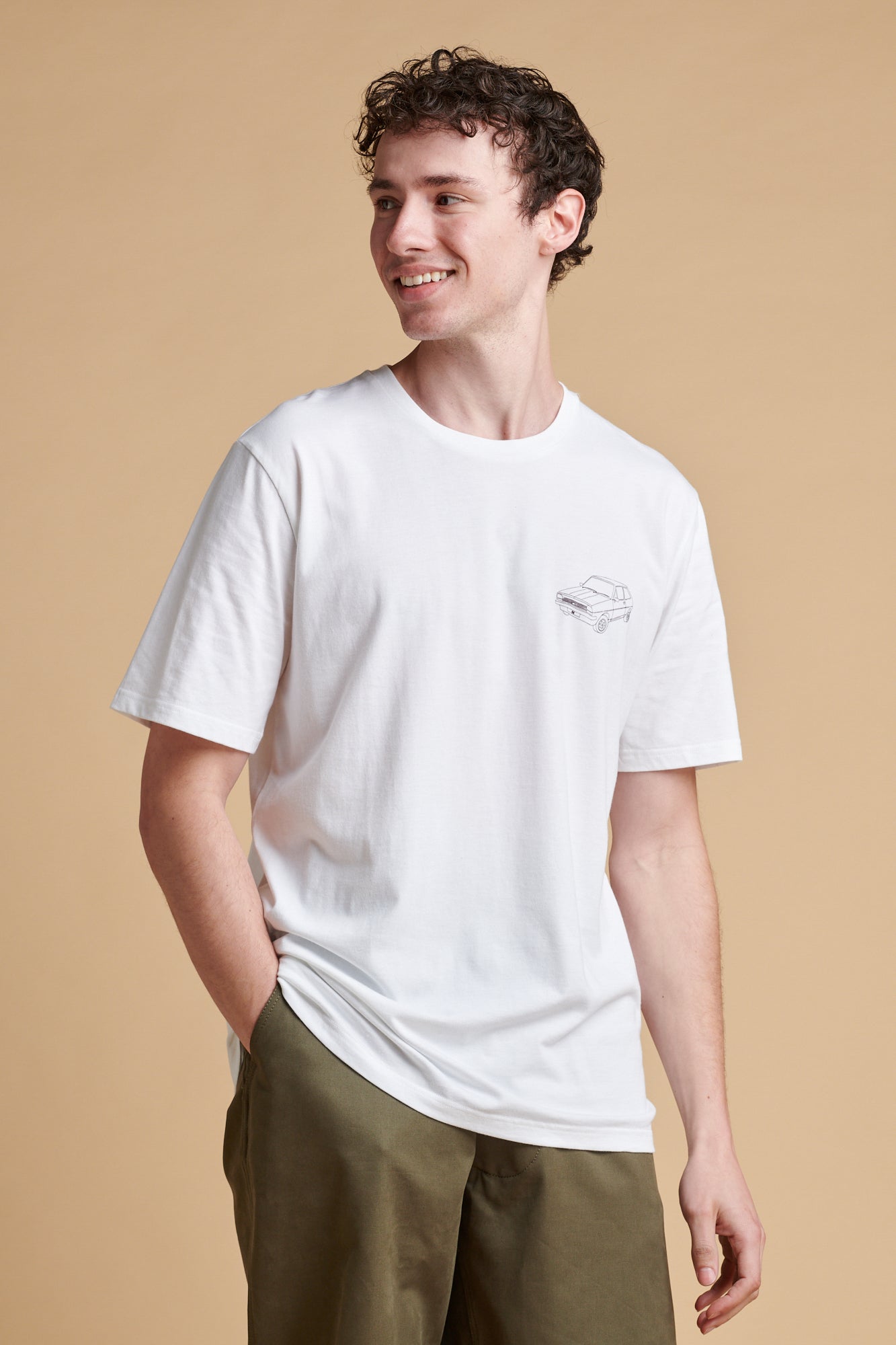 Male wearing short sleeve graphic t shirt in white with Fiesta car print.