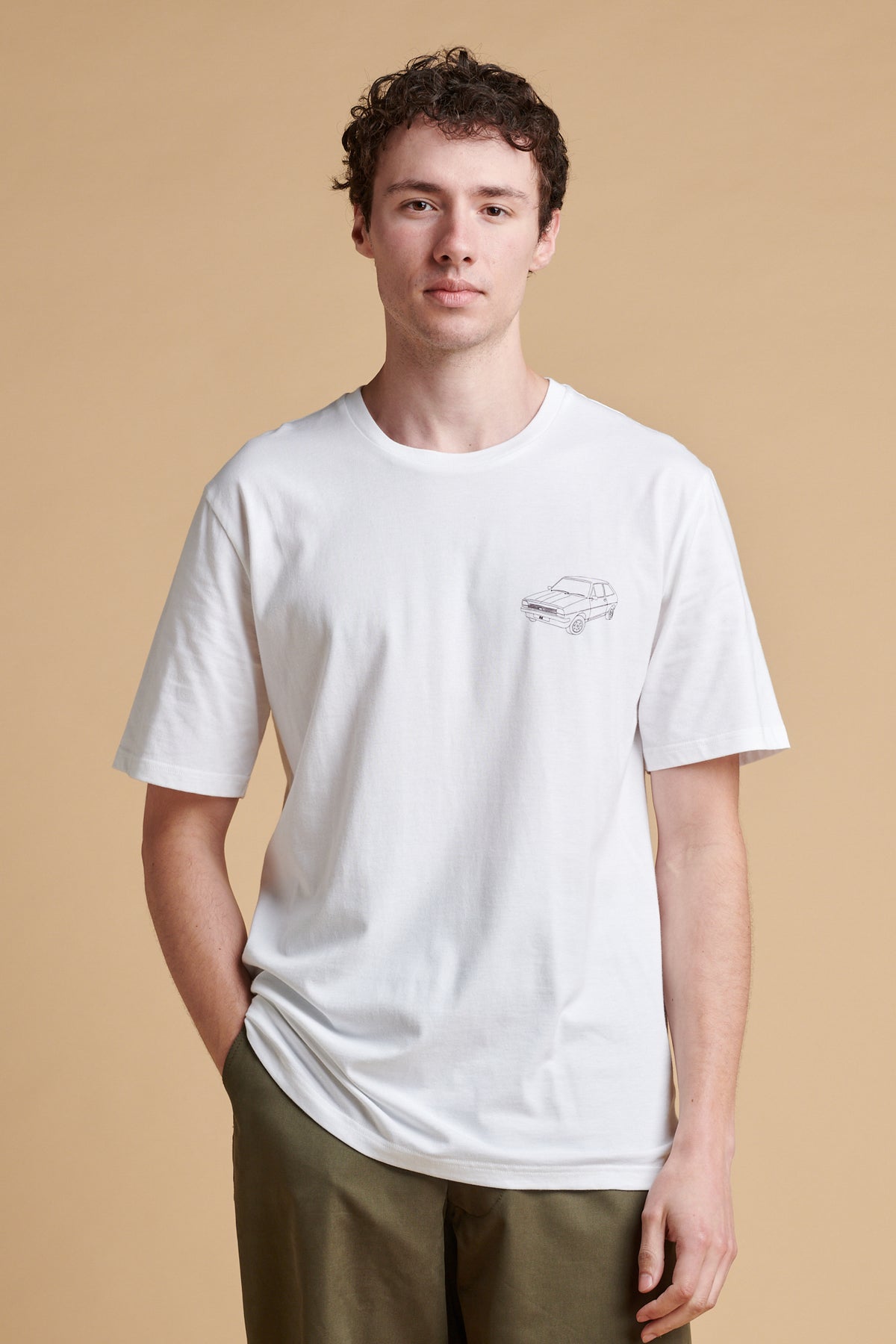 Male wearing short sleeve graphic t shirt in white with Fiesta car print.