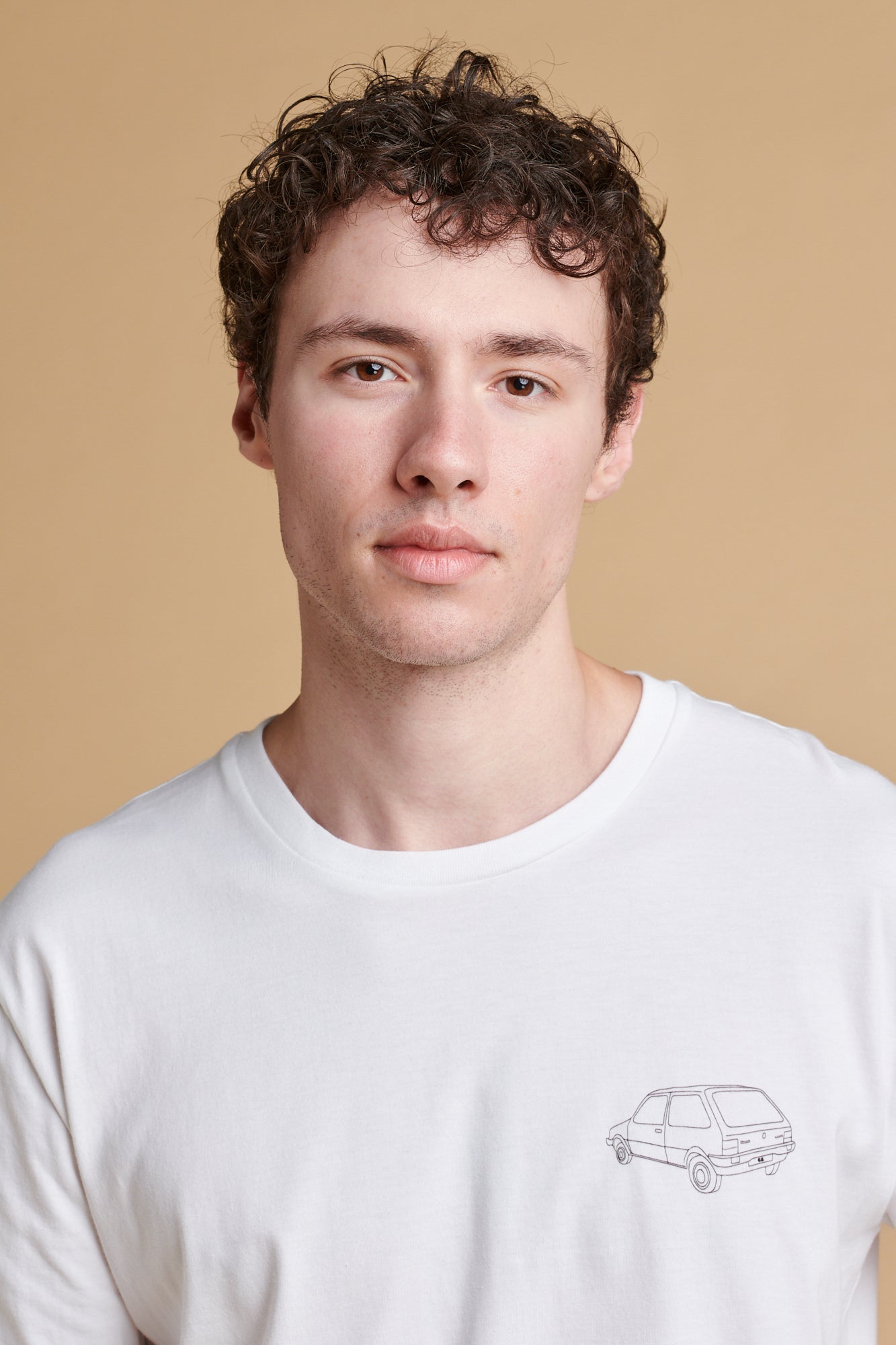Portrait of male wearing short sleeve graphic t shirt with Metro car print.