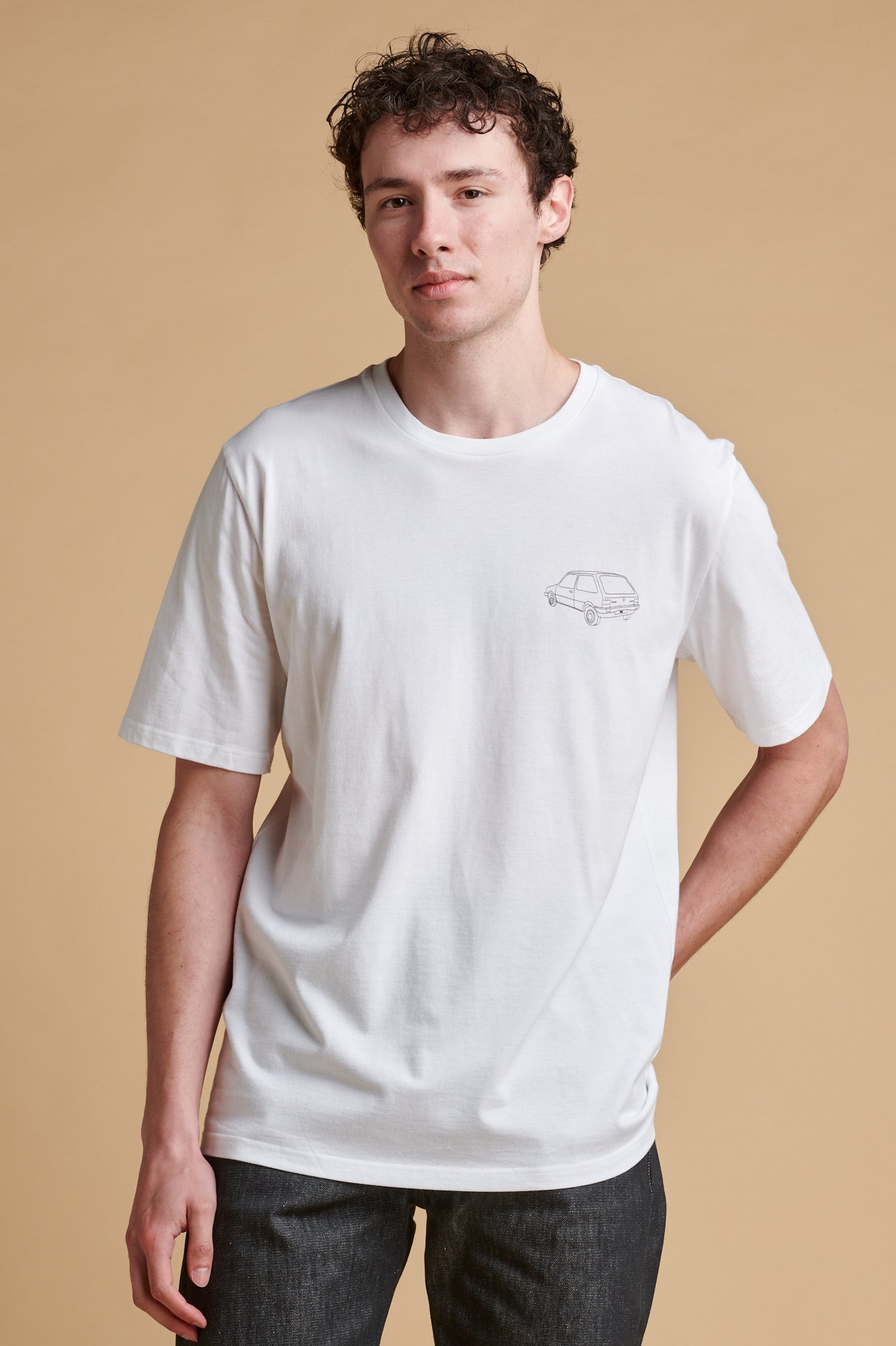 Portrait of male wearing short sleeve graphic t shirt with Metro car print.