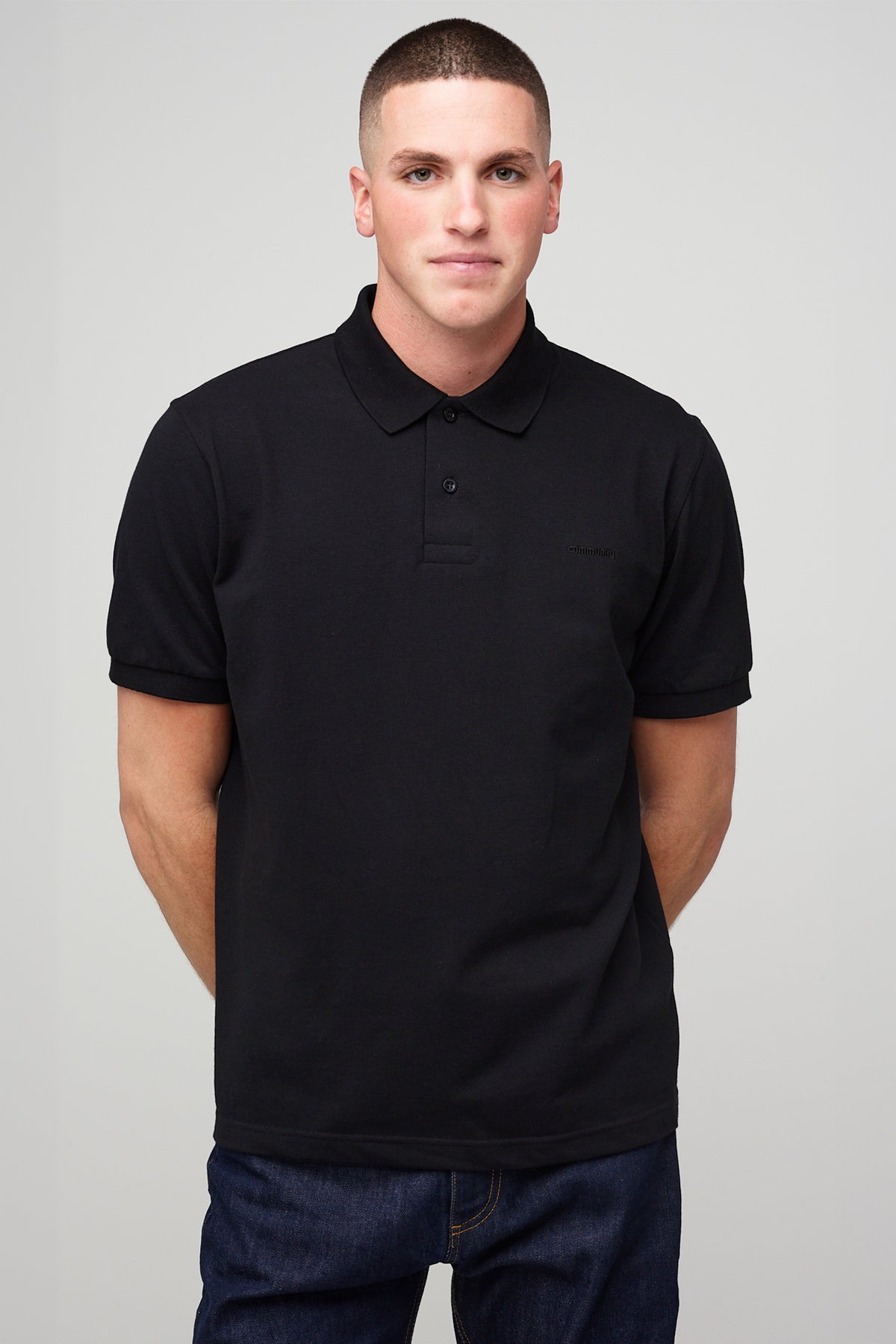 
            male in short sleeve polo shirt - black