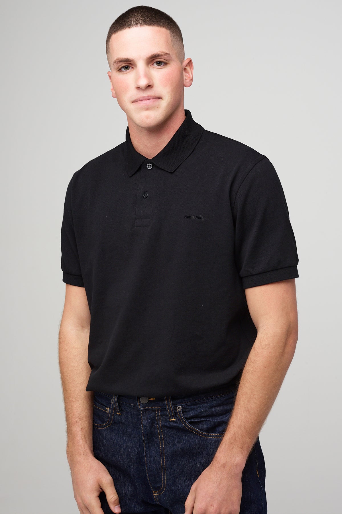 
            Male in short sleeve polo shirt - black