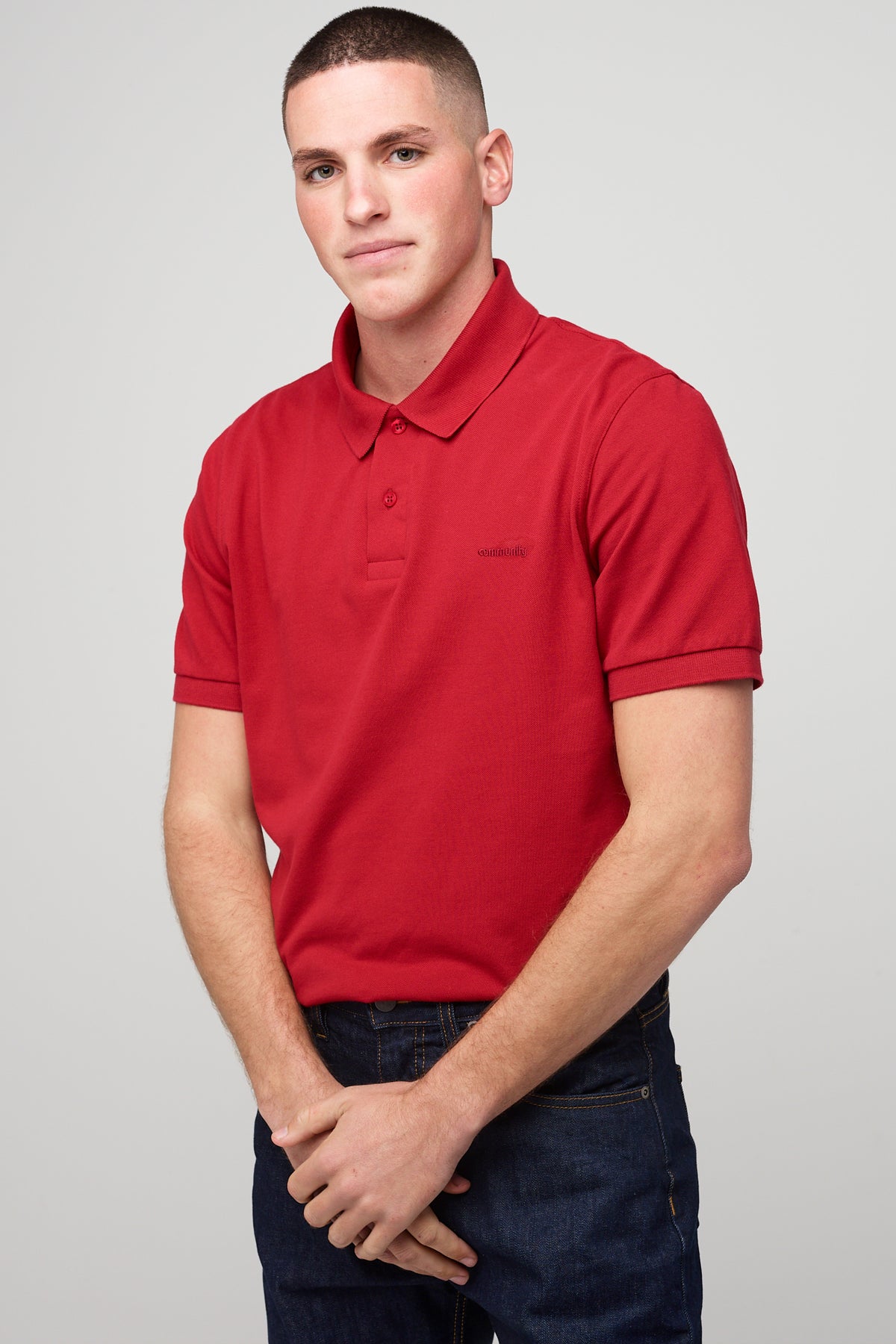 
            Brunnet male in short sleeve polo shirt crimson