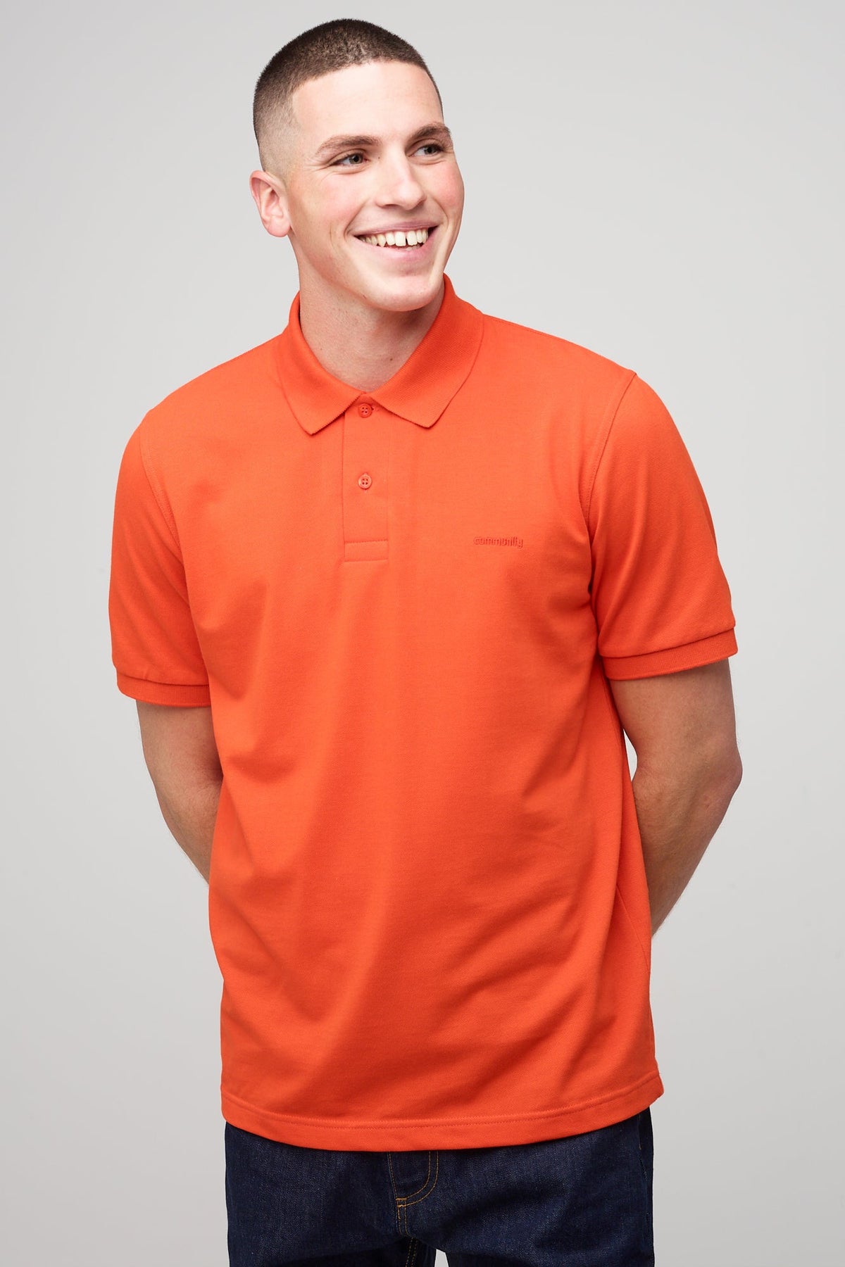 
            Brunet, white male in flame red short sleeve polo t-shirt 