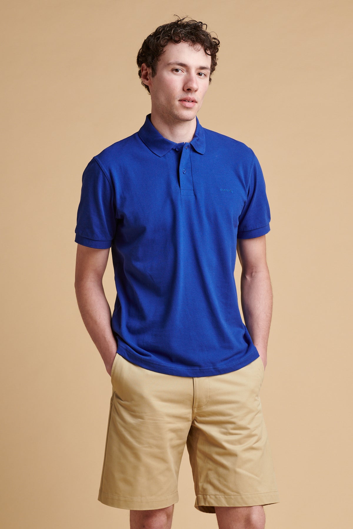 Male wearing short sleeve polo shirt in royal blue.