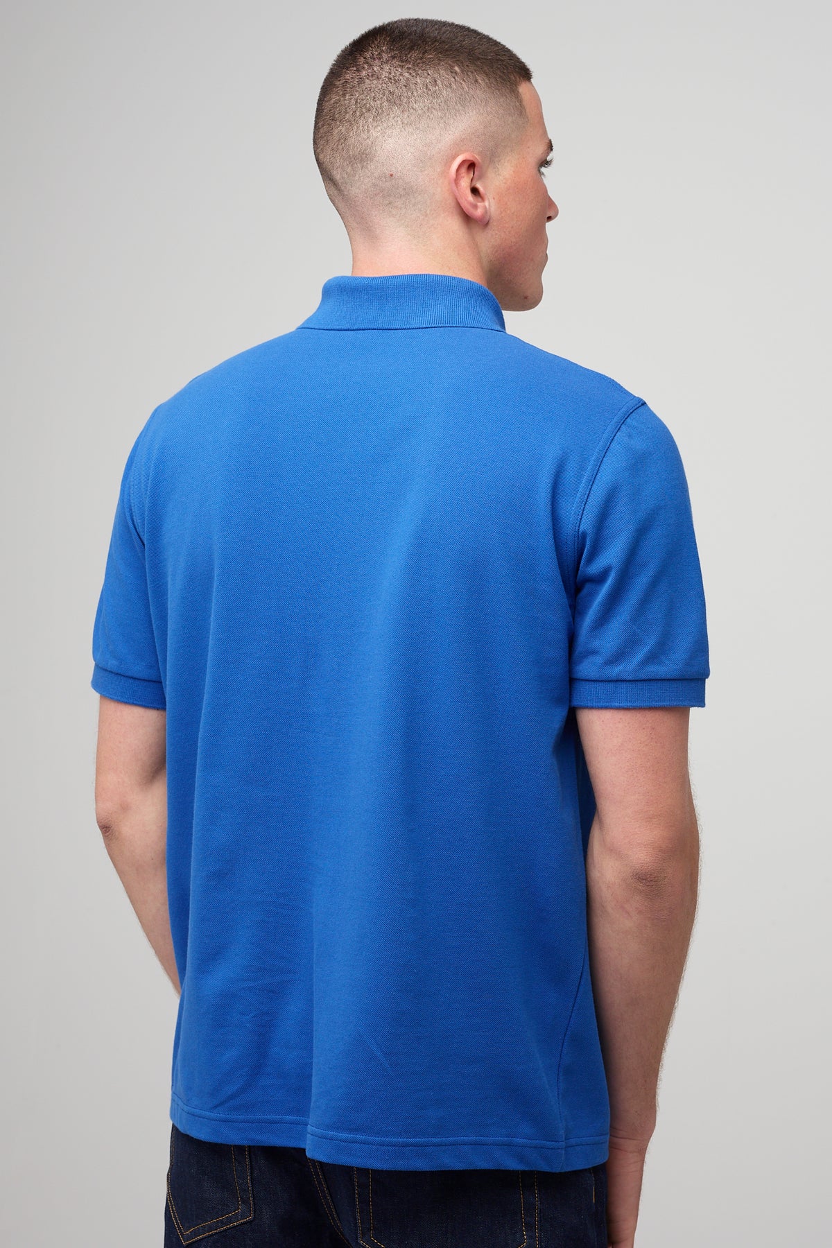 
            male in short sleeve polo shirt in cobalt