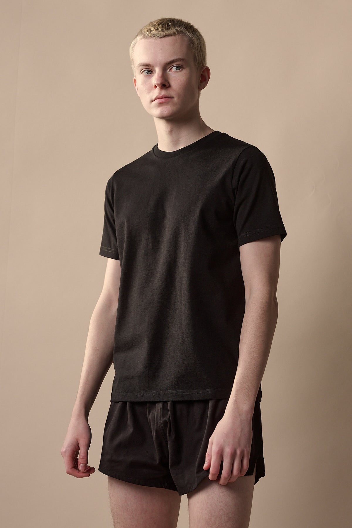 
            Thigh up image of white male wearing short sleeve t shirt plastic free in black 