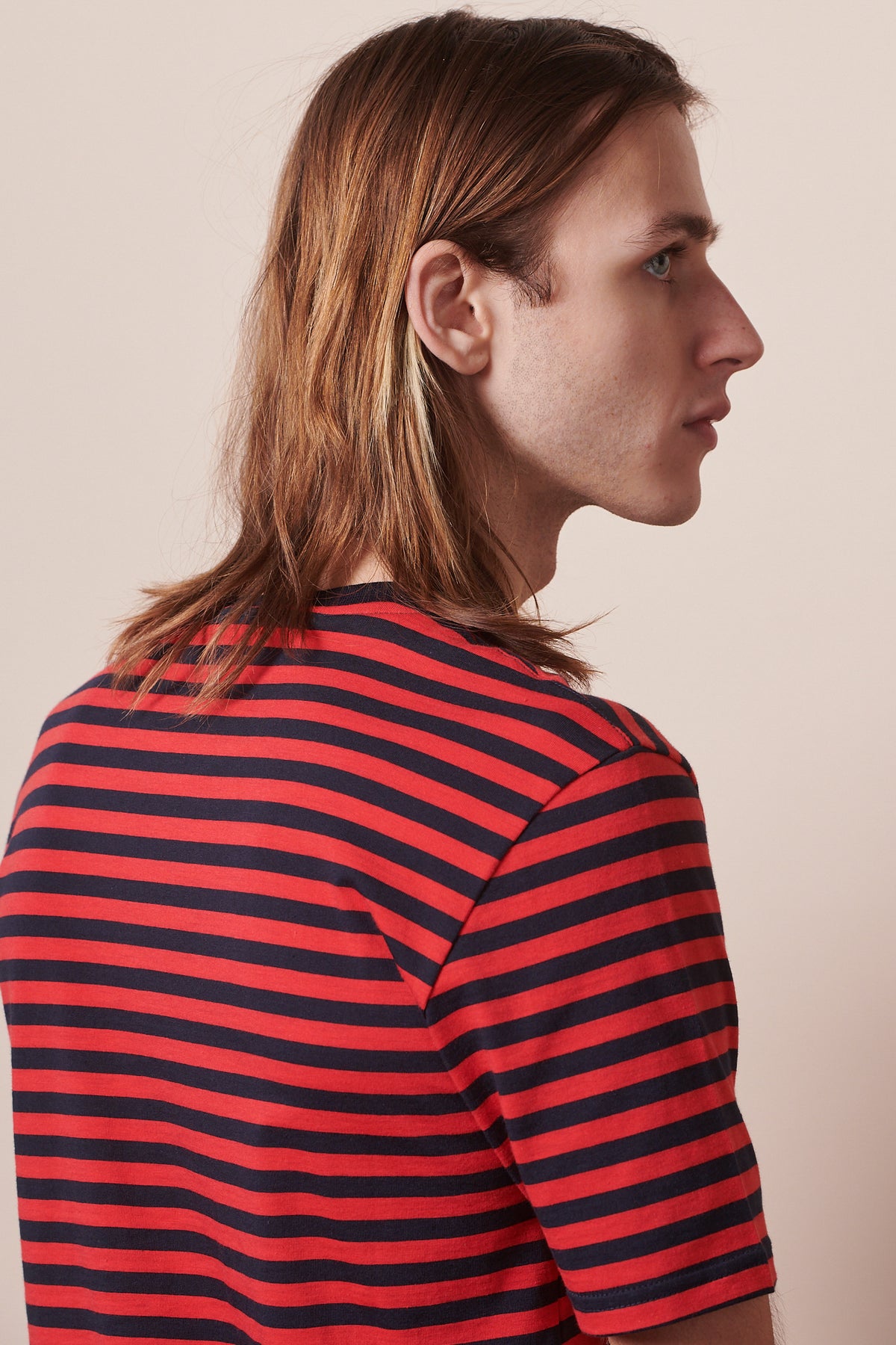 back of male wearing navy red striped short sleeve t shirt