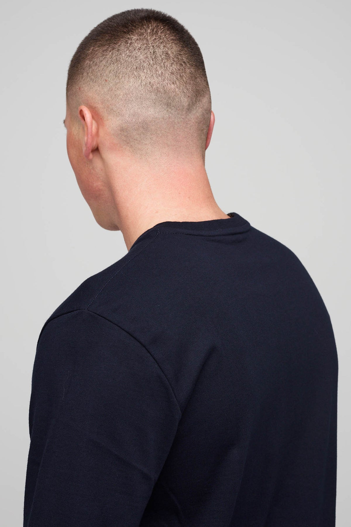
            Back of male in short sleeve T-shirt Navy