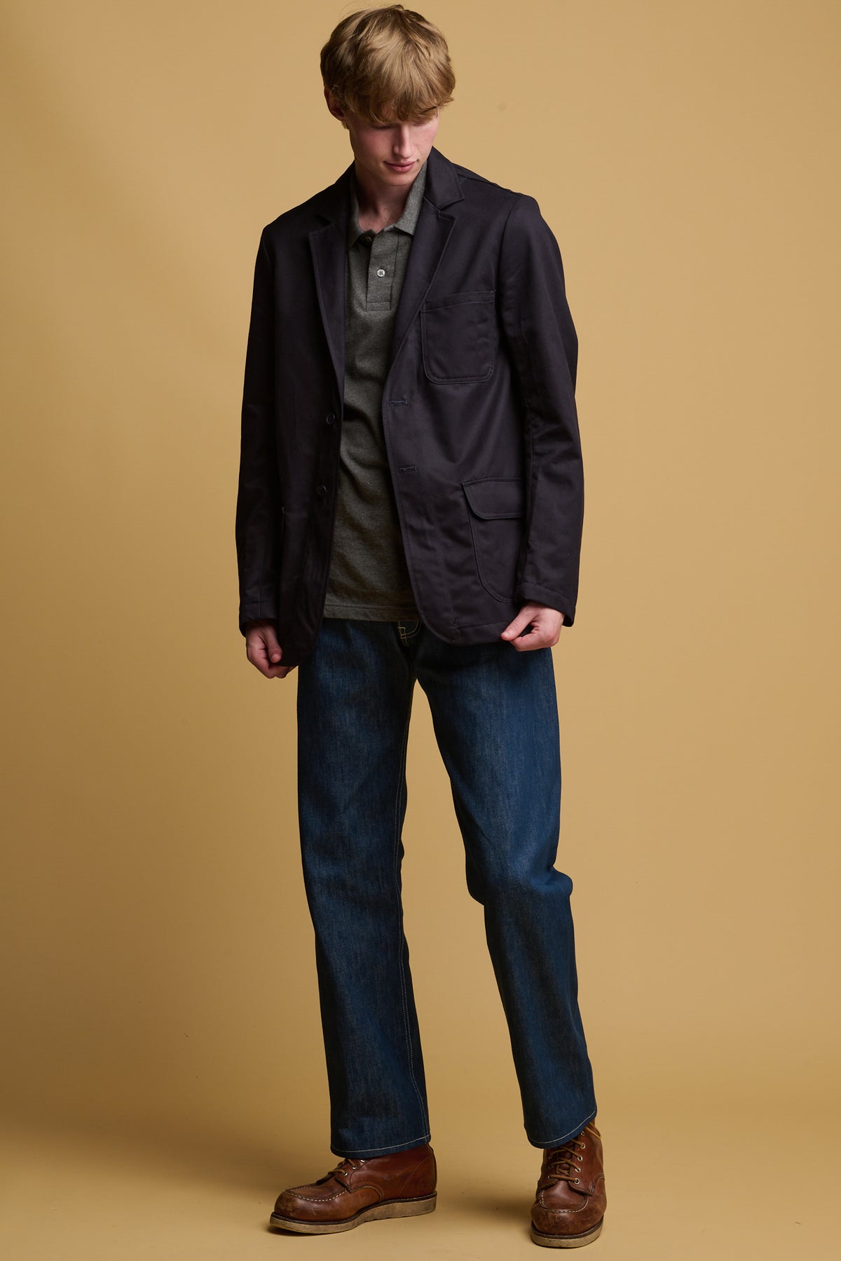 
            Male wearing James cotton blazer in navy worn with arran jean in blue