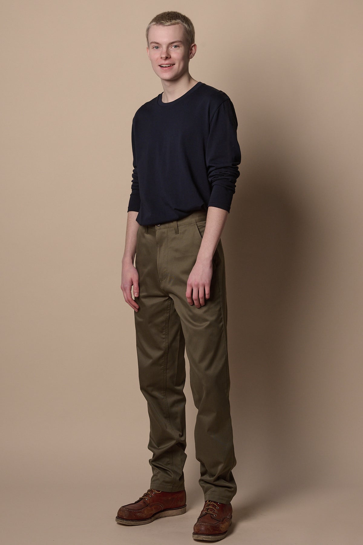
            Full body image of white male wearing slim chino in olive, paired with long sleeve t shirt in navy