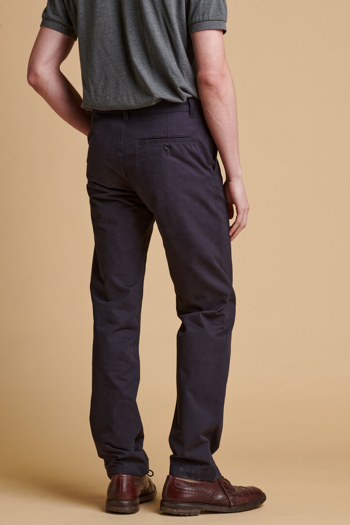 Male wearing slim heavyweight cotton twill chinos in dark navy.