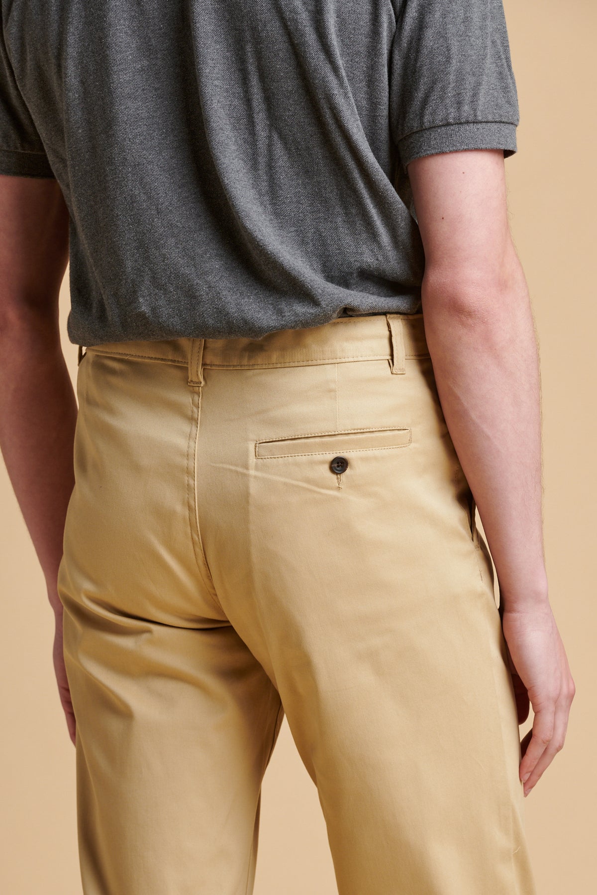 the back of male wearing slim lightweight stretch chino in stone.