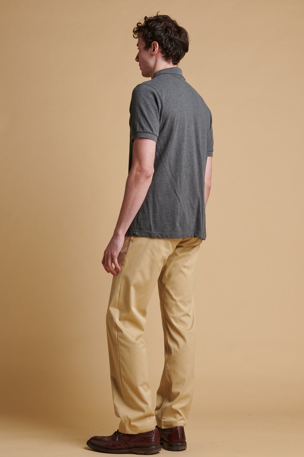 The back of male wearing slim lightweight stretch chino in stone.