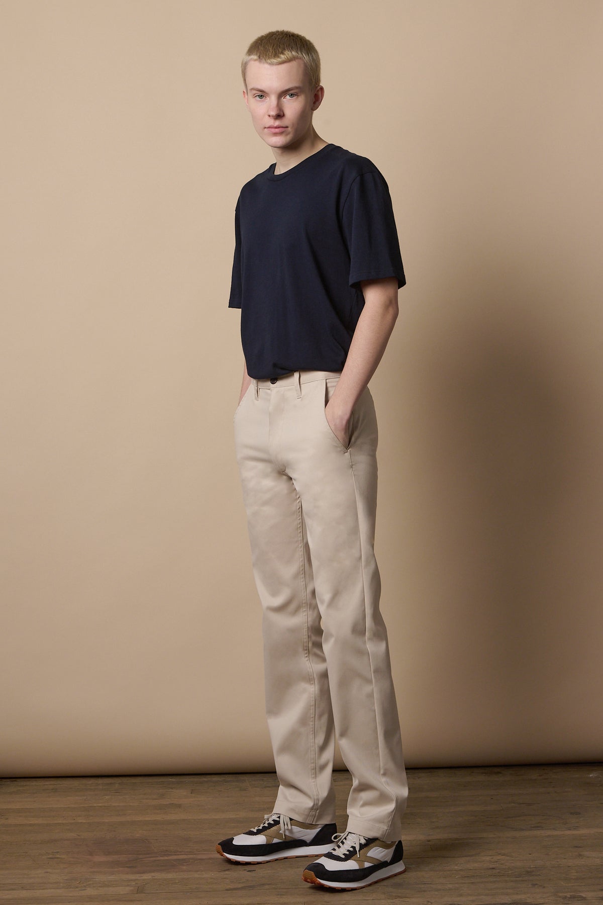 Full body image of male wearing slim stretch chino in light stone