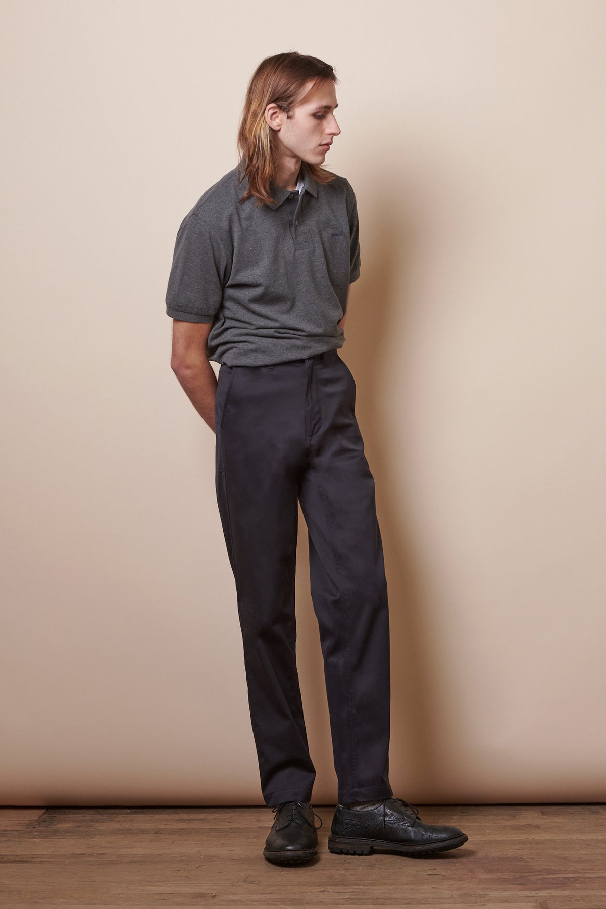 
            Full body image of white male with shoulder length brown hair wearing Men&#39;s Slim Stretch Chino in navy paired with short sleeve polo shirt