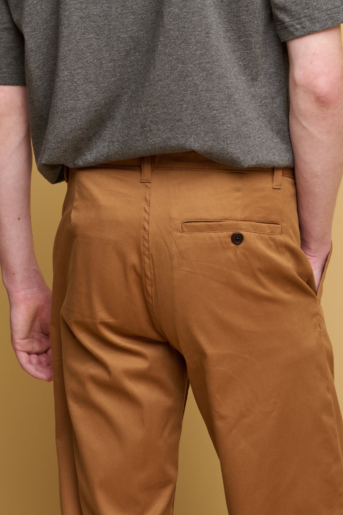 
            back pocket with button detail of slim stretch chino in tobacco