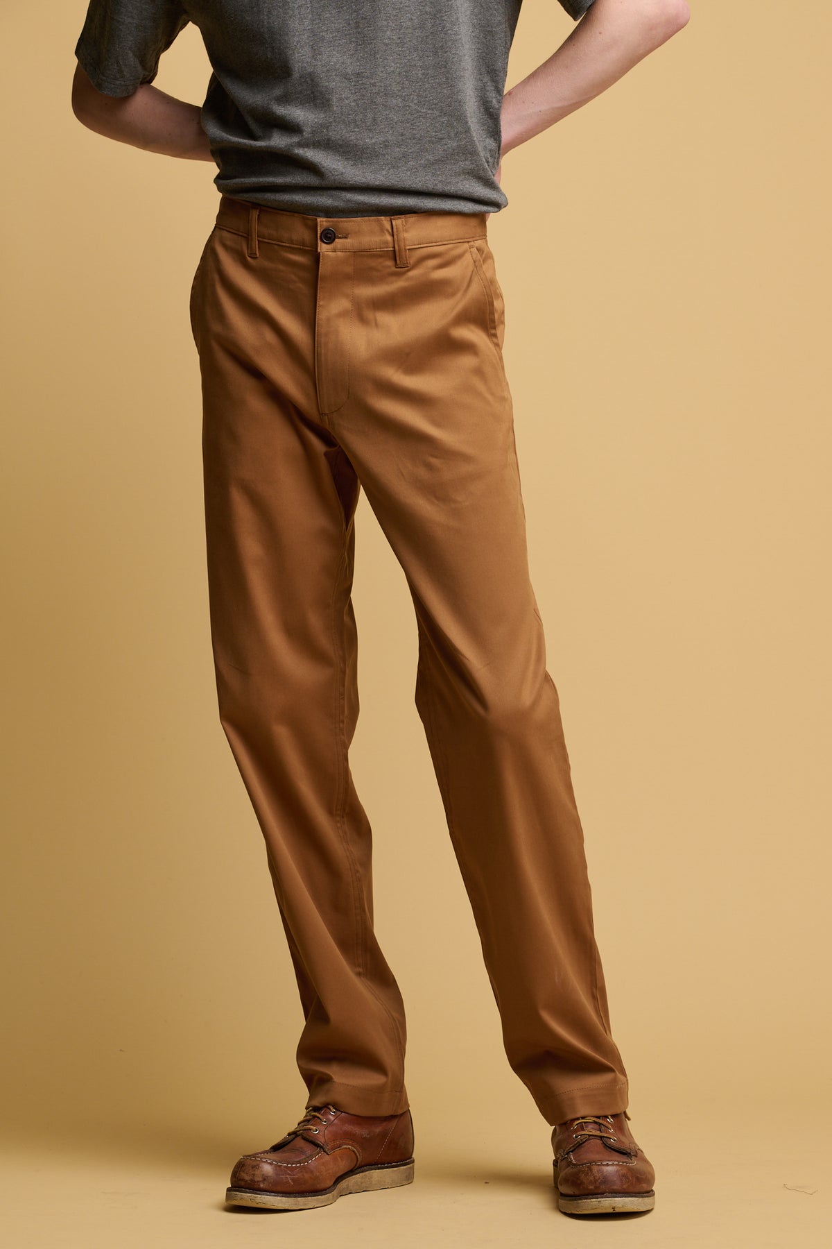 Shoulder down of male wearing community clothing slim stretch chino in tobacco