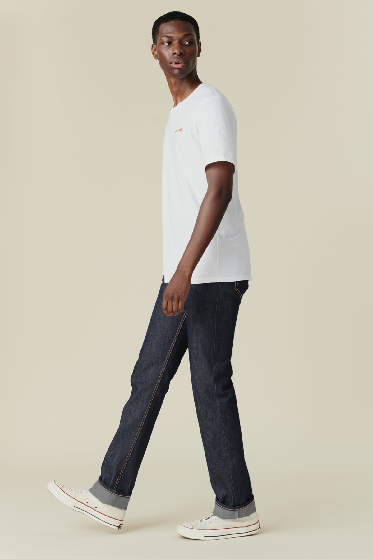 
            Full body image from the side of black male wearing straight cut jeans in indigo 
