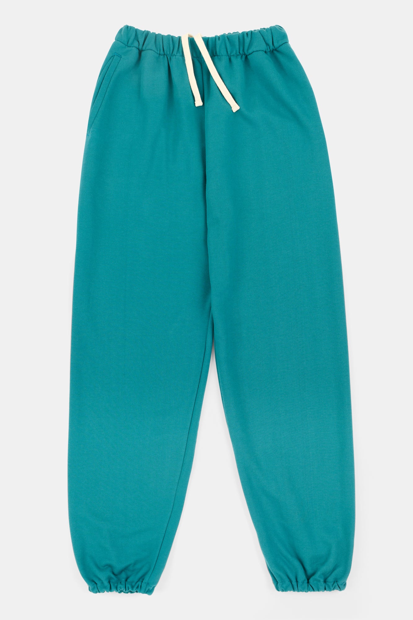 Flatlay of men's sweatpants in teal with ecru adjustable drawcord through the waistband and elasticated hem