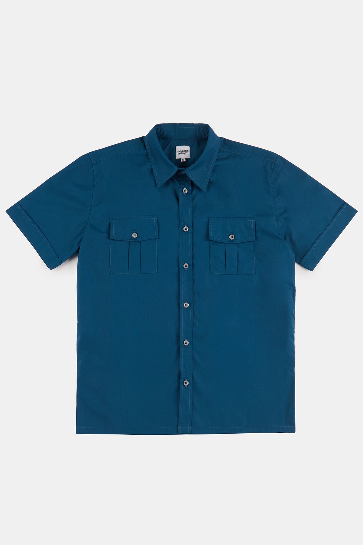 
            Flatlay product shot of men&#39;s short sleeve military two pocket shirt in light blue