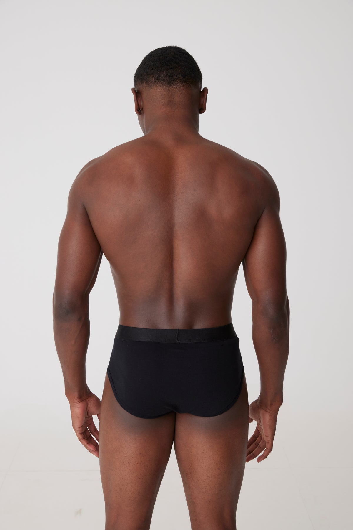 Black male facing away wearing black y- fronts