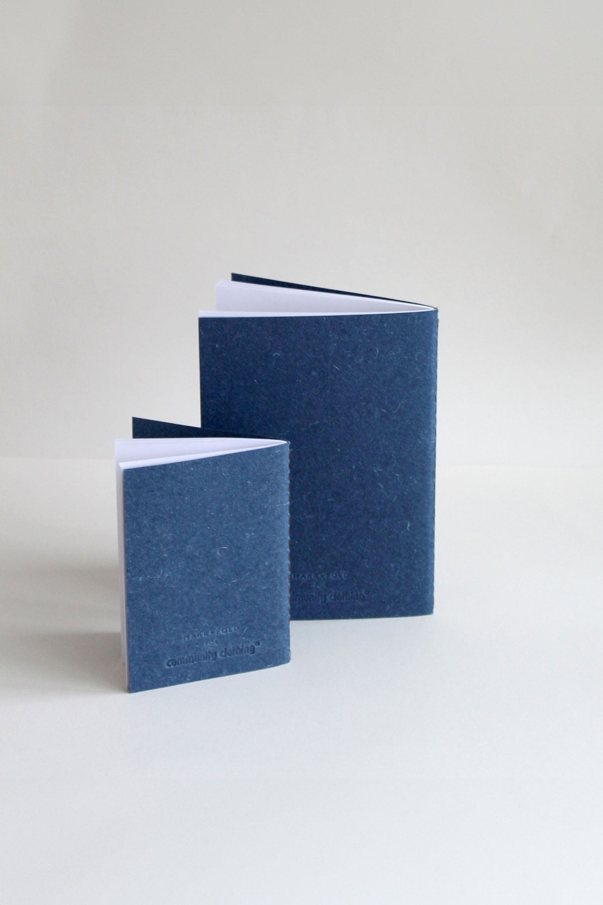 
            The back of A5 and A6 indigo notebook set showing the embossed logo.