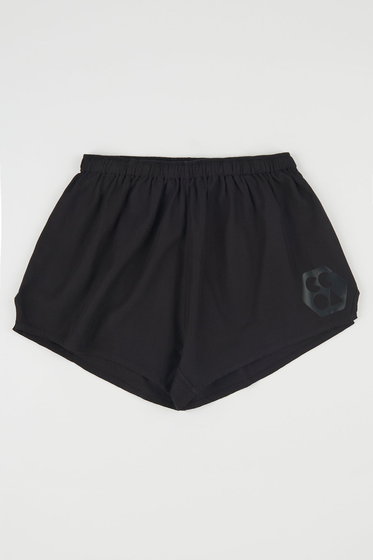 Flatlay product shot of men's lightweight sports short plastic free in black with CCOA logo