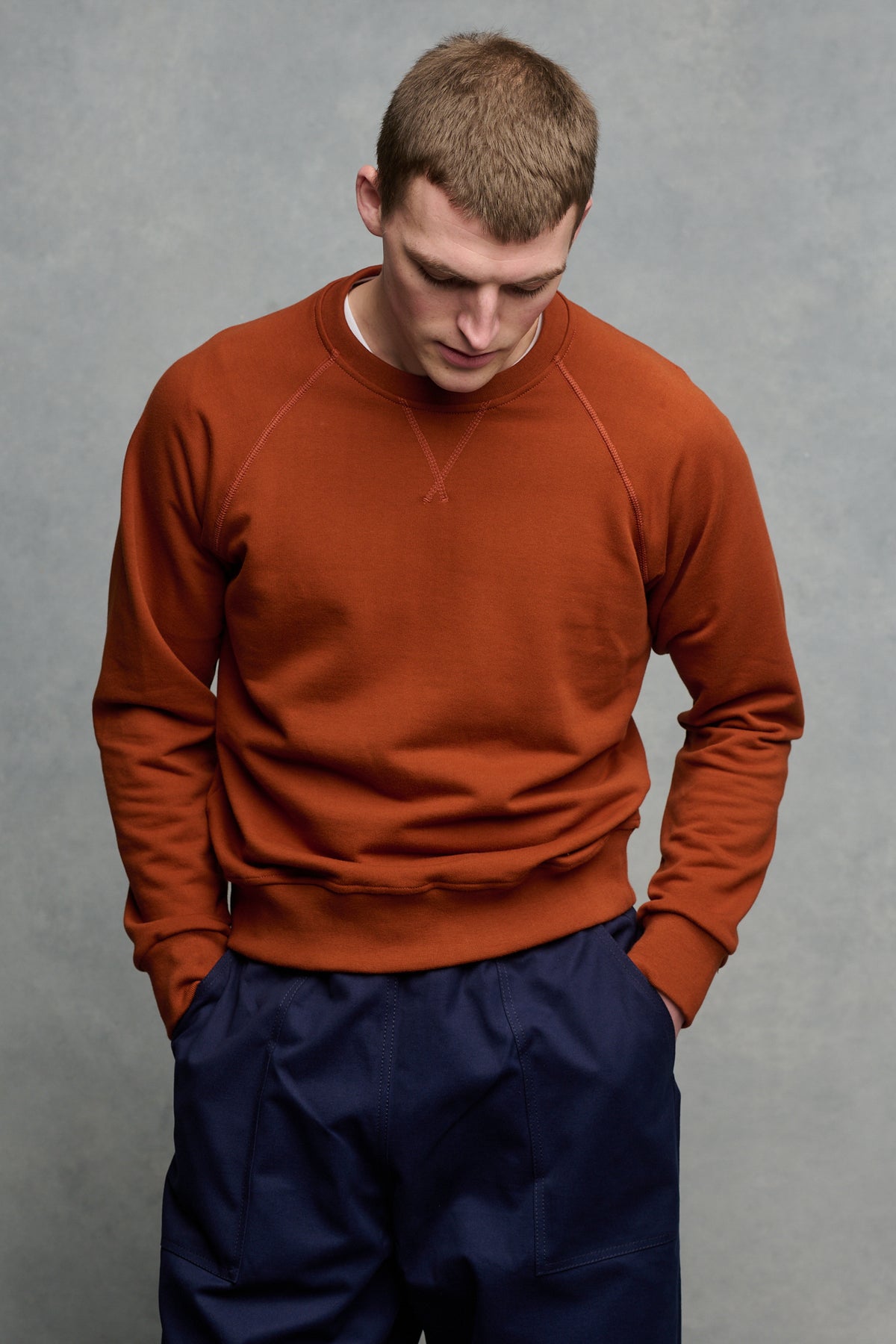 
            Thigh up image of male wearing cinnamon raglan sweatshirt