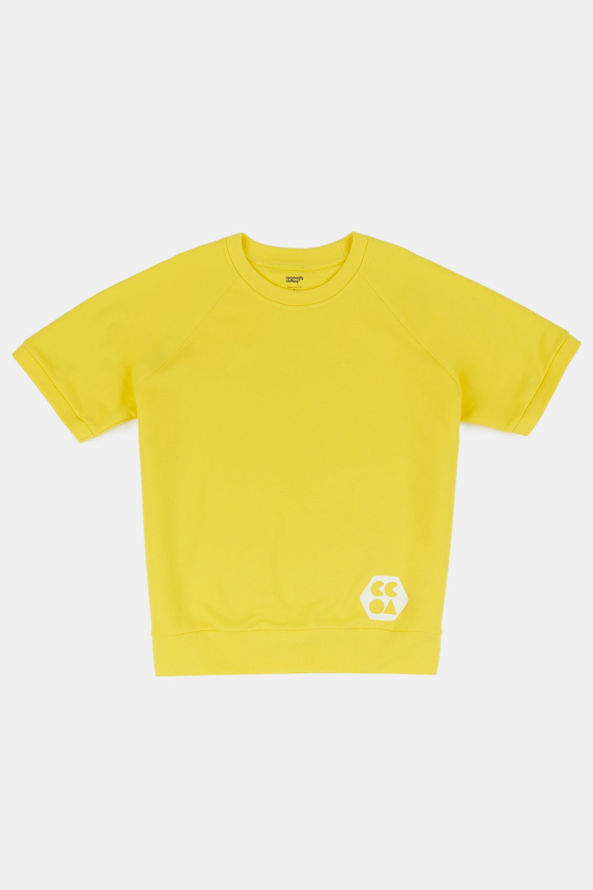 
            Flatlay product shot of men&#39;s short sleeve raglan training top plastic free in canary yellow with white CCOA logo