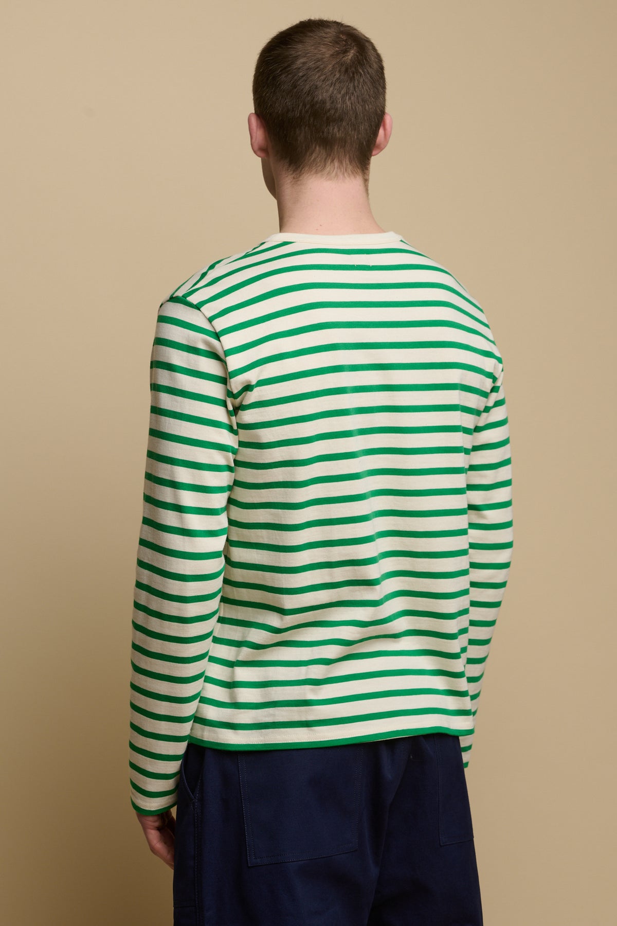 
            Thigh up image of the back of brunet male wearing Breton in ecru green
