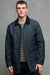 Thigh up image of brunet male wearing car coat in navy unzipped open over Breton in charcoal and grey marl