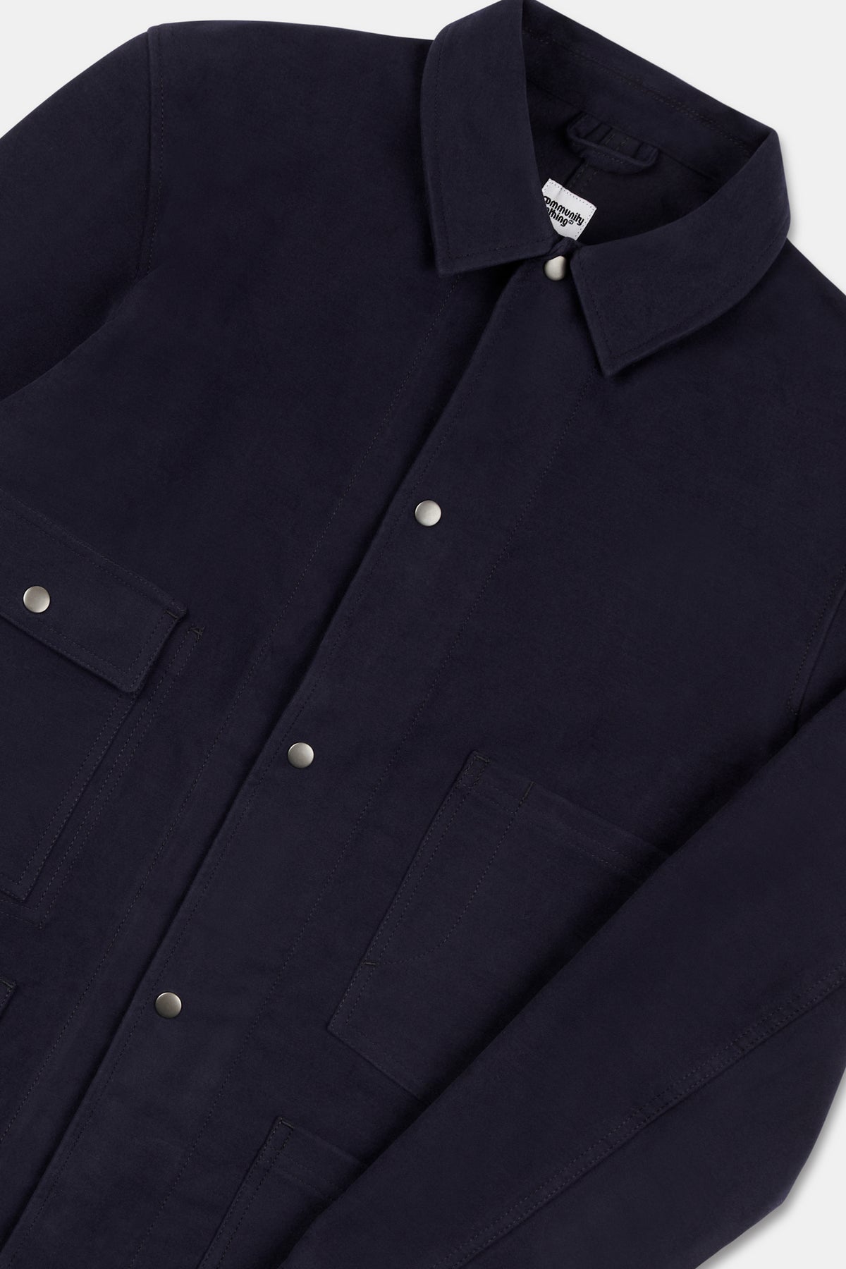 Close up flatlay of mens Carter moleskin chore jacket in navy.