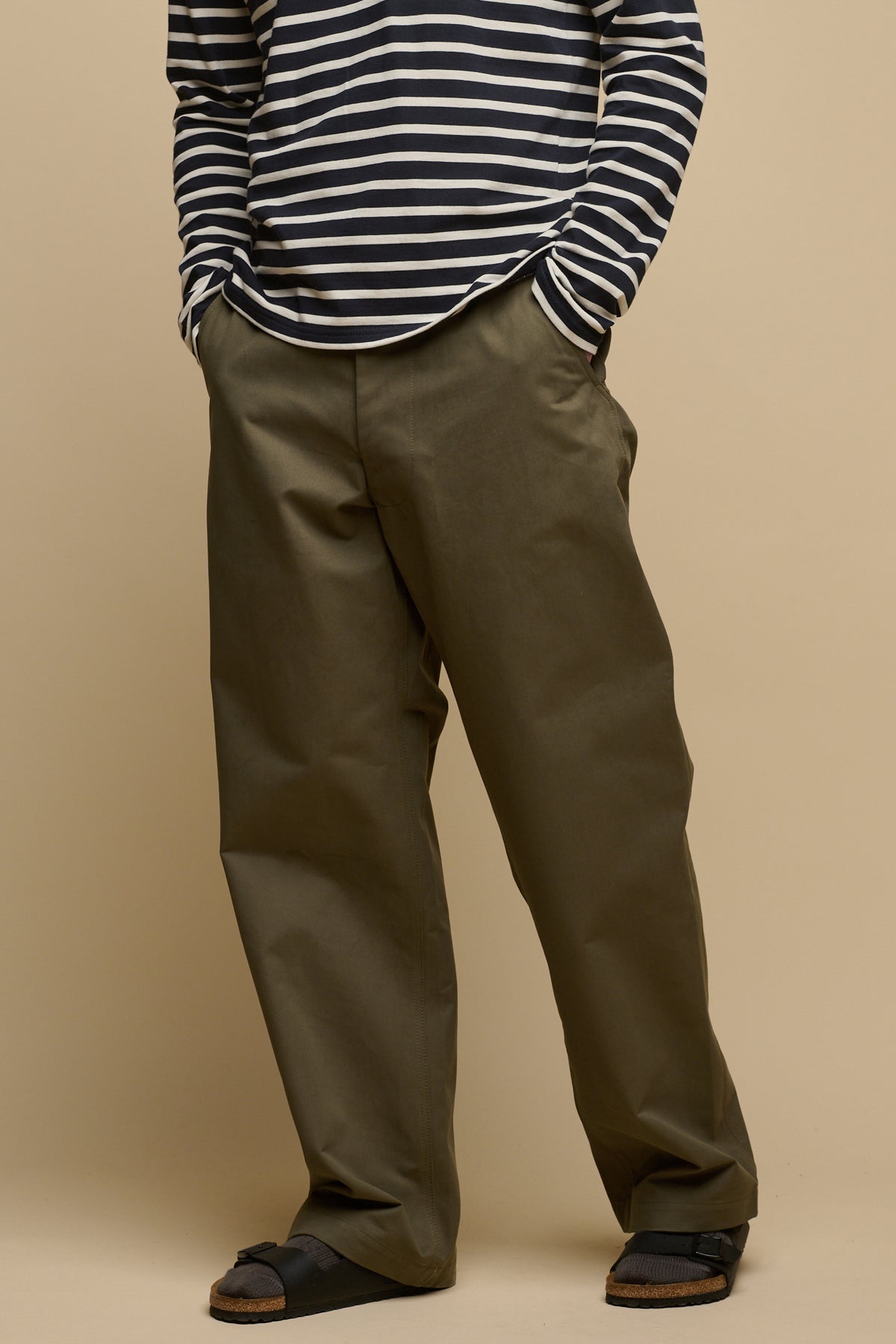 
            Chest down image of male wearing breton in navy ecru with men&#39;s field trousers in olive