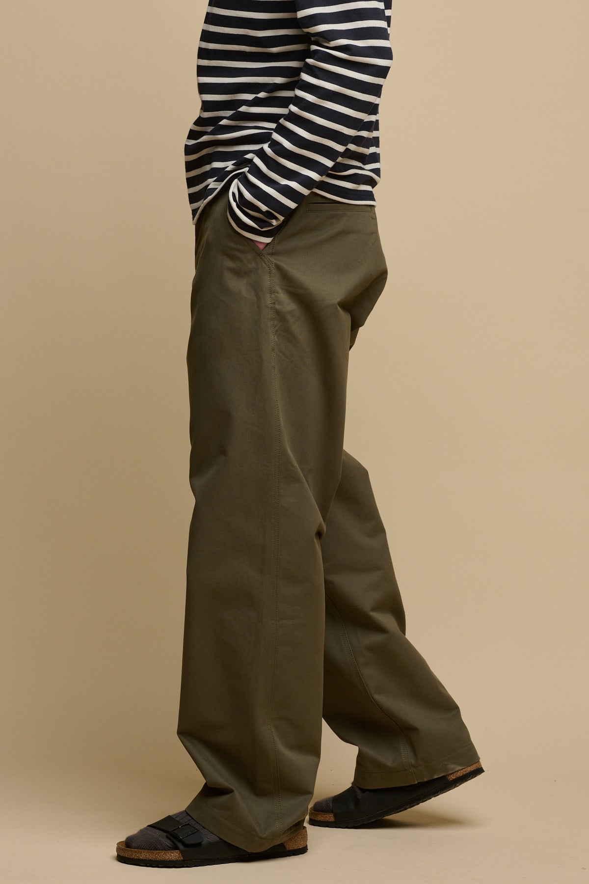 
            The side of male wearing field trousers in olive with hand in front pocket