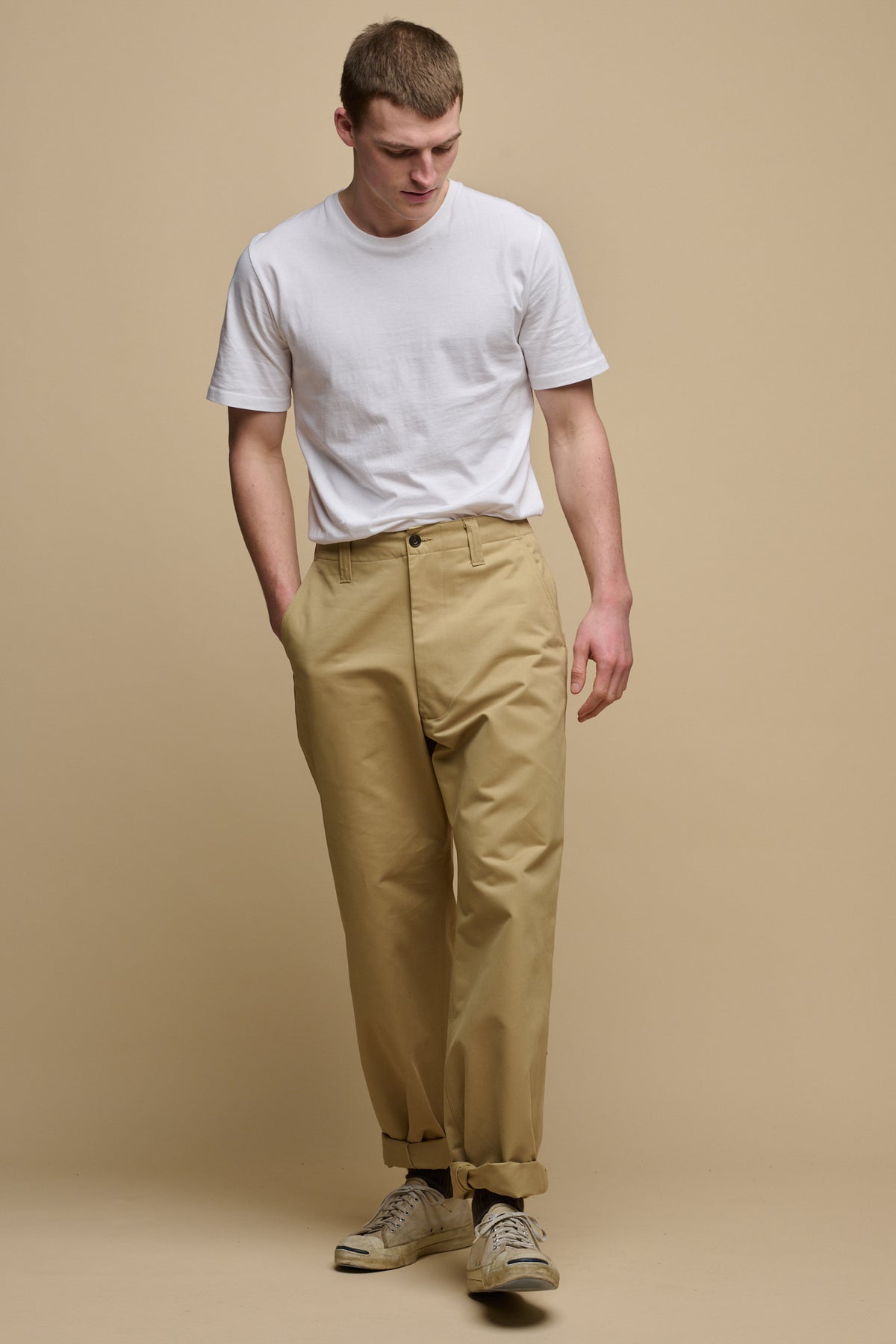 
            Full body image of male wearing men&#39;s field trousers in stone paired with short sleeve t shirt in white tucked into trousers