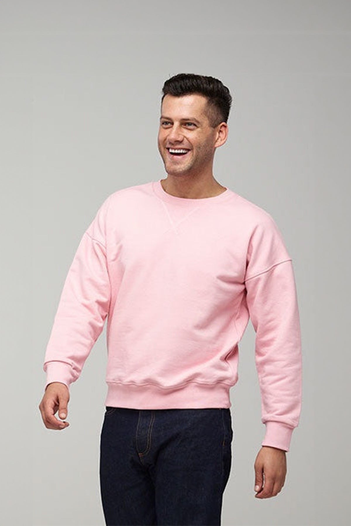 
            Smiley male wearing Community Clothing Men&#39;s Drop Shoulder Sweatshirt in pale Pink
