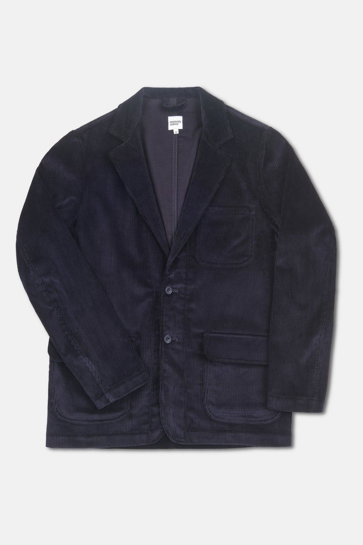 Navy corduroy blazer on pale grey background 
