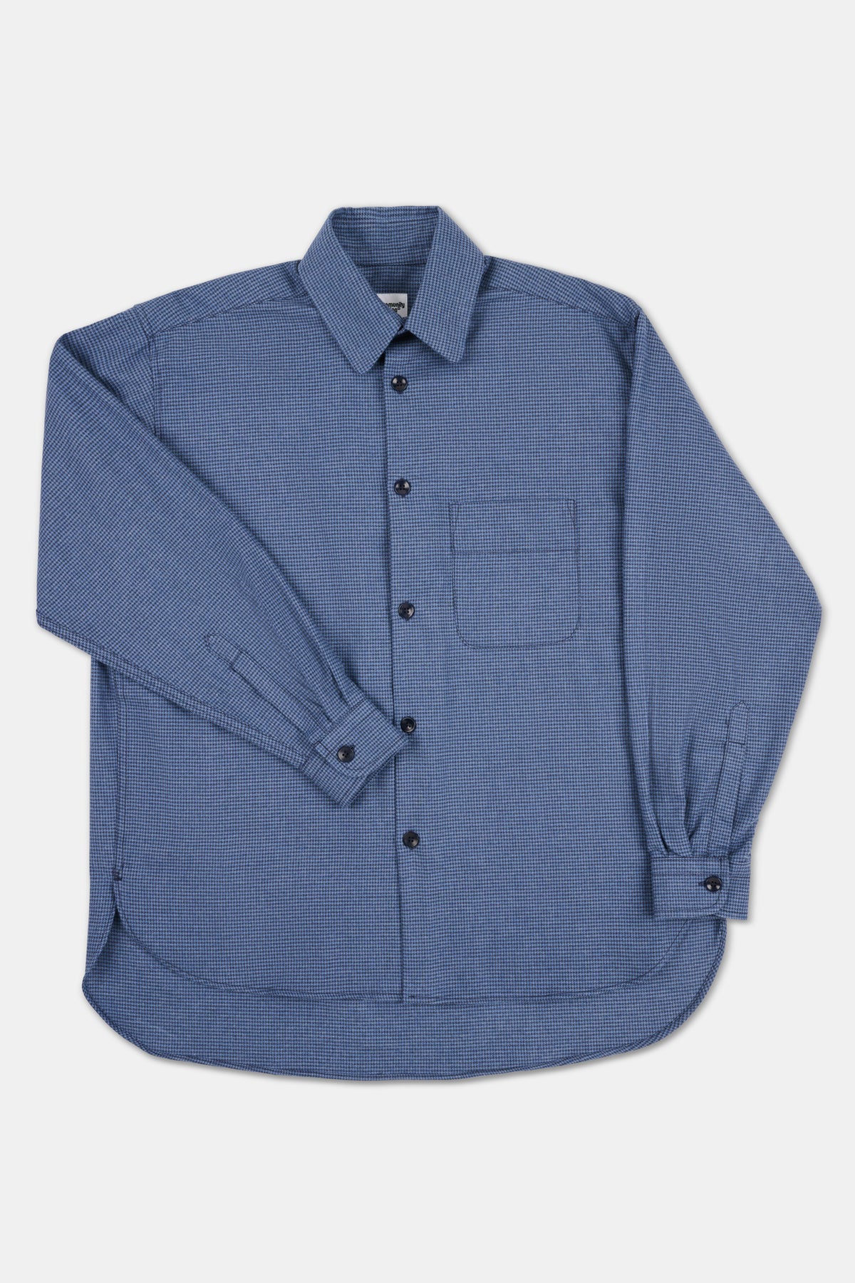 Long sleeve blue shirt on white background. 