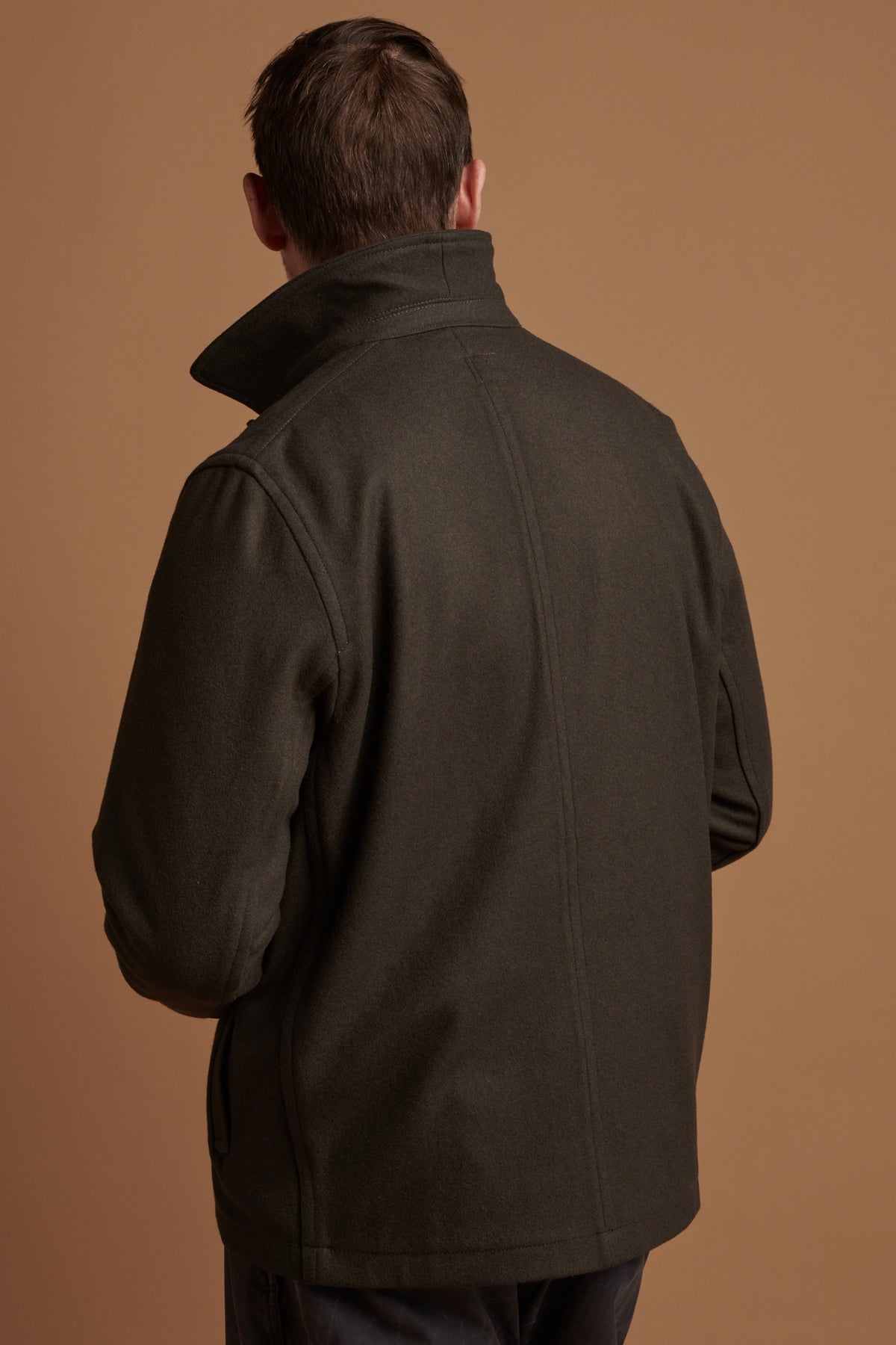 The back of Patrick wearing Drab Arthur wool chore jacket with collar up.