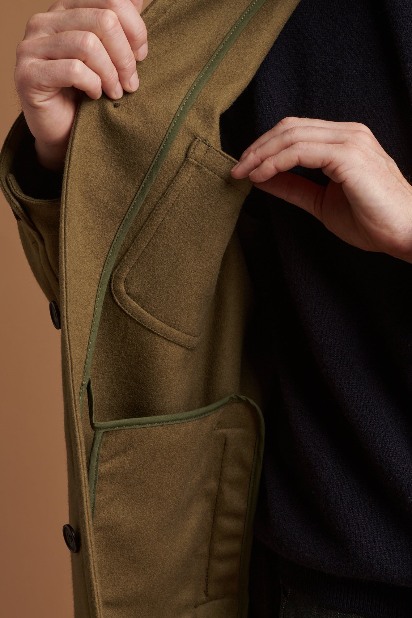 The inside pocket of Arthur wool chore jacket in olive