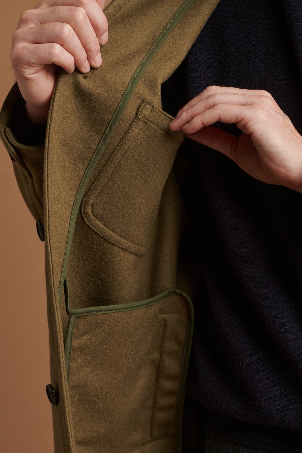 The inside pocket of Arthur wool chore jacket in olive