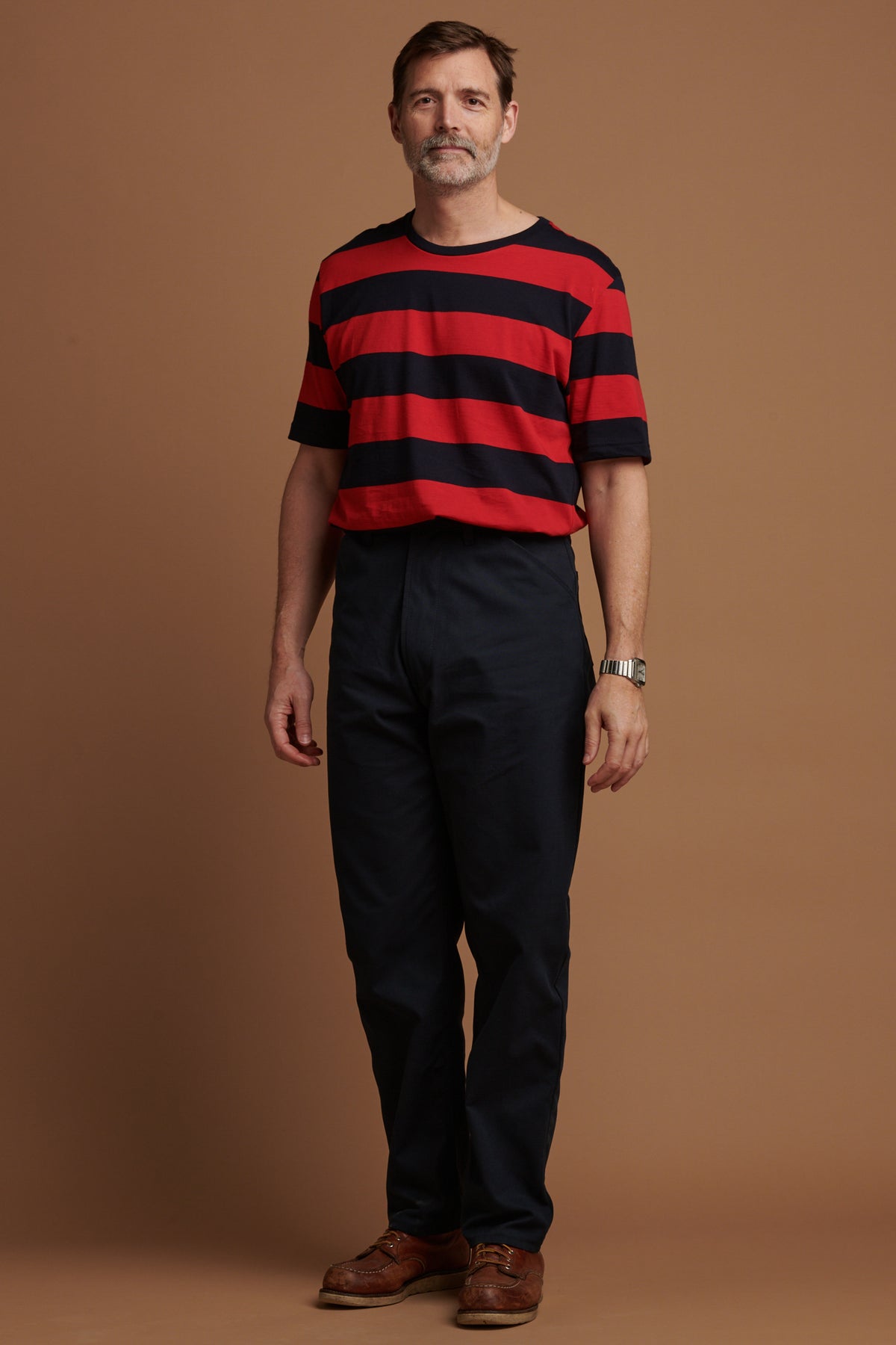 The front of Patrick Grant wearing canvas chore trousers in navy