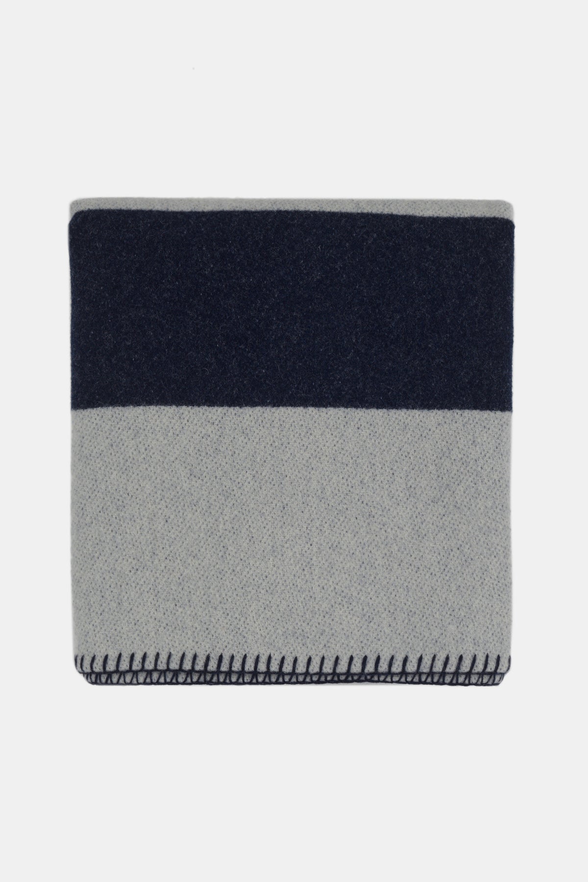 
            Flatlay image of folded pure wool striped blanket in navy ecry