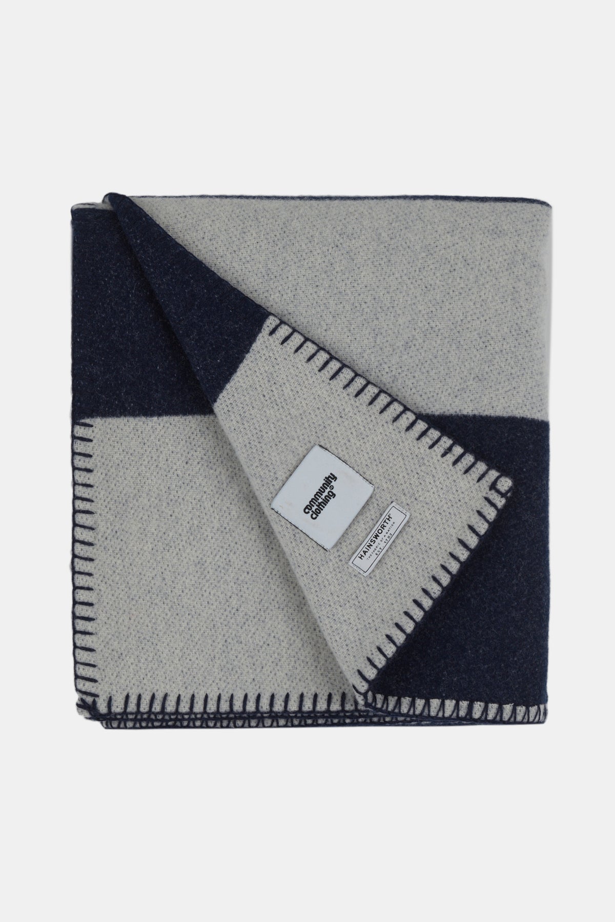 
            Flatlay image of folded pure wool striped blanket in navy ecry