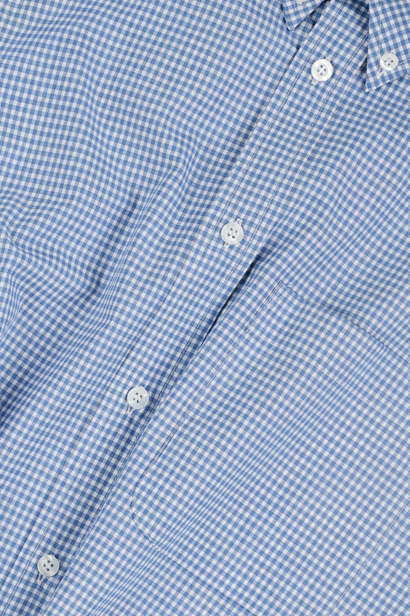 Close-up of a blue checkered shirt with buttons